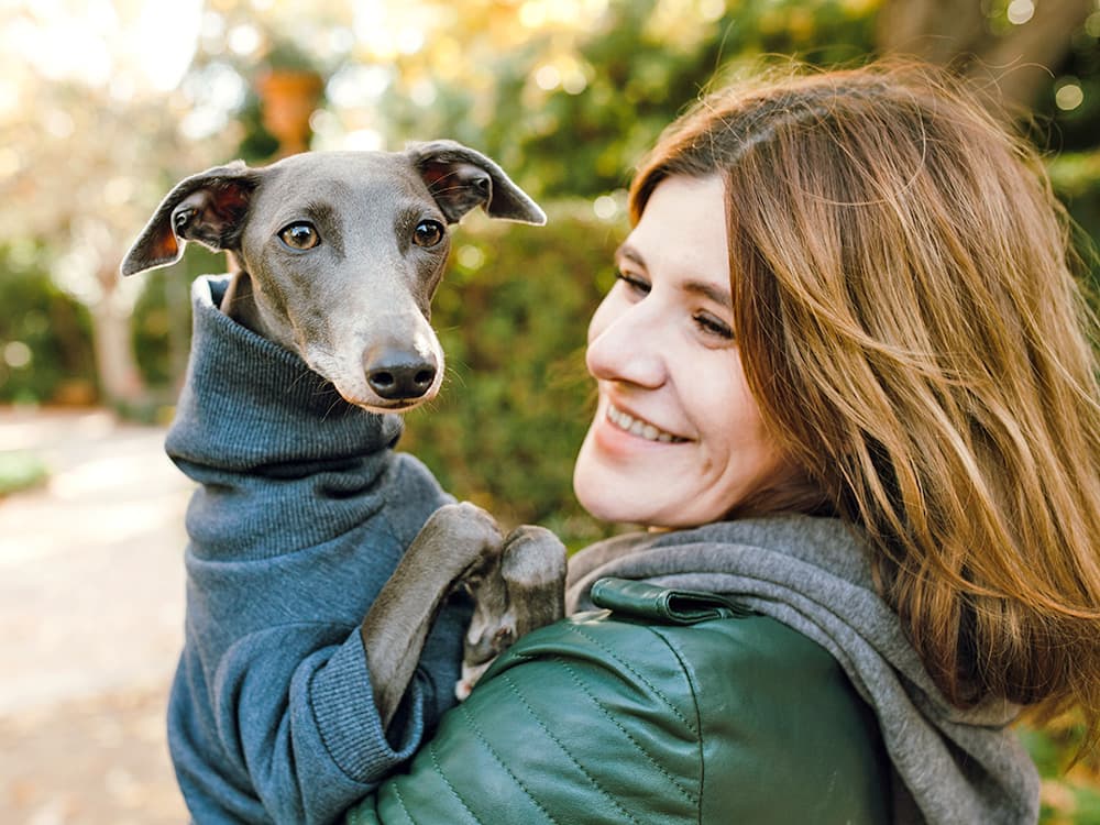 Woman with her Italian Greyhound outside.
