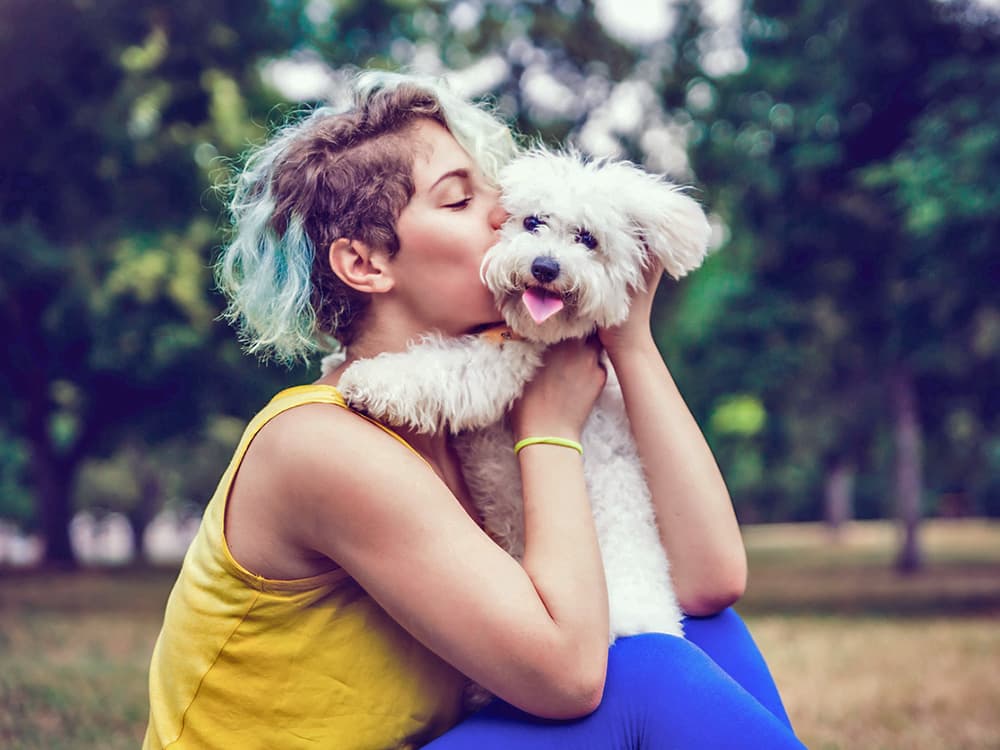 woman holding mini poodle