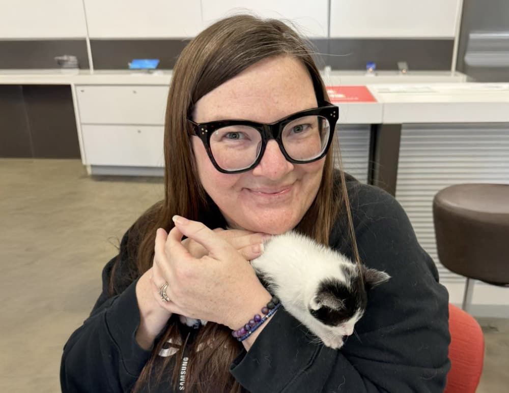 Woman cuddling kitten