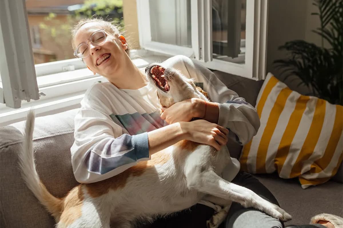 Woman laughing with dog
